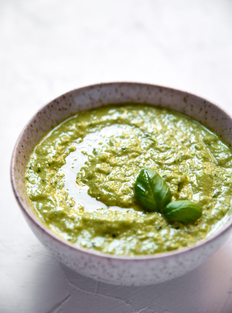 garlic scape and basil pesto in a bowl on a white background