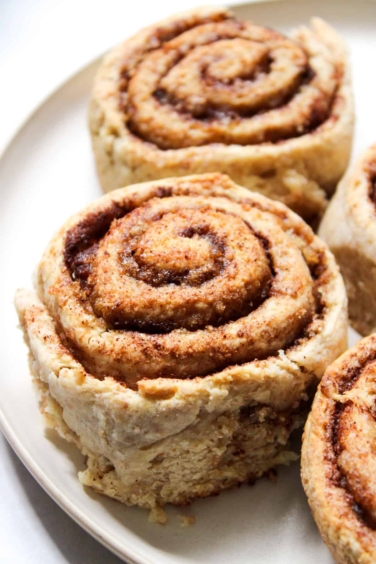 whole wheat cinnamon rolls served on a beige plate