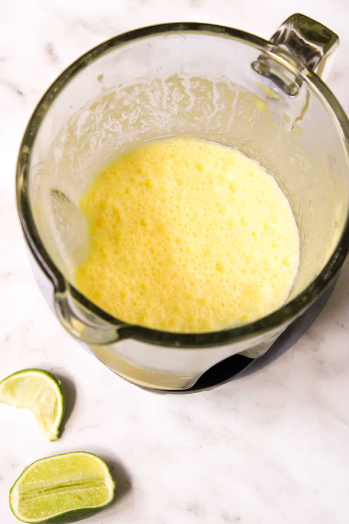 overhead view of the blended pineapple drink in a blender