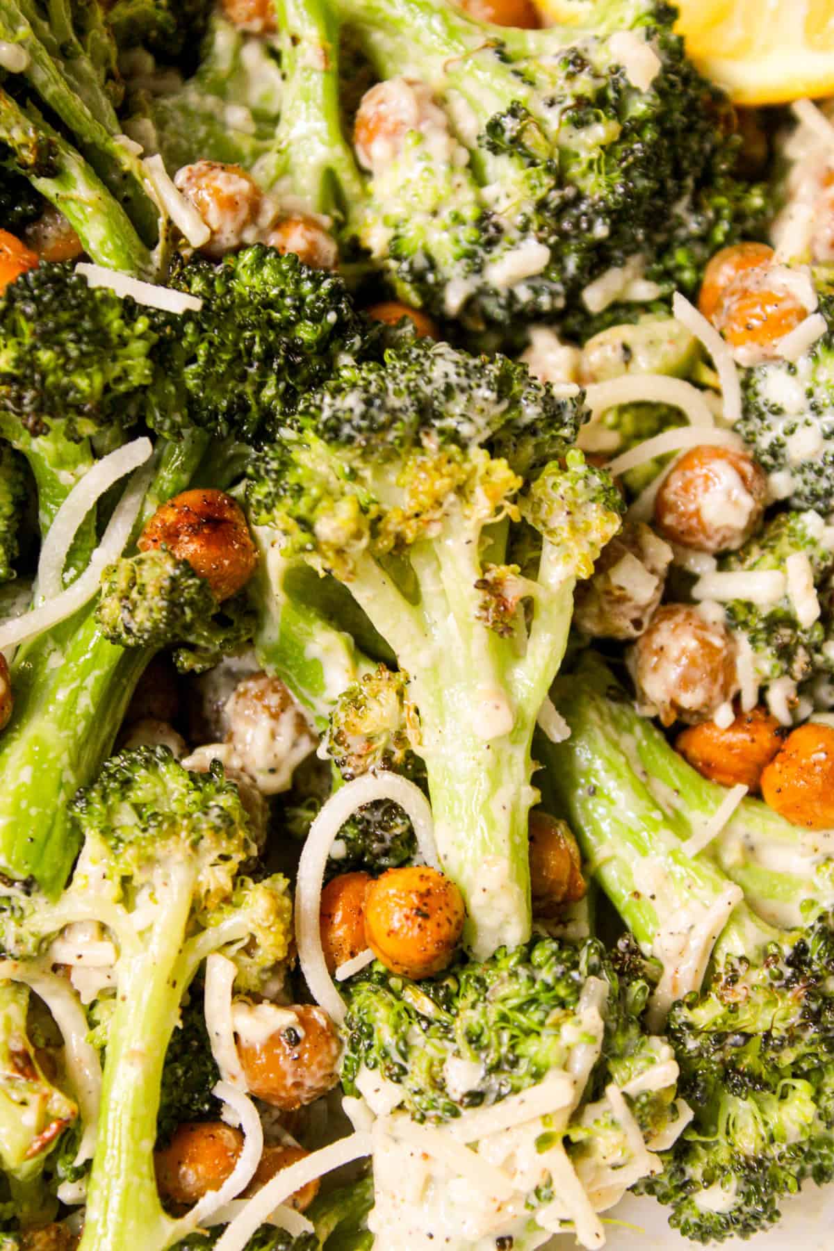 close up of roasted broccoli with tahini caesar dressing and crispy chickpea croutons